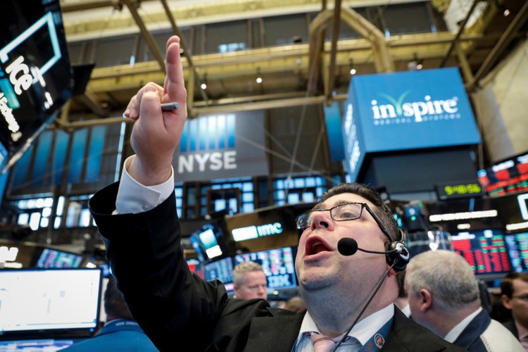 Trader Michael Capolino shouts out a bid on the floor of the New York Stock Exchange