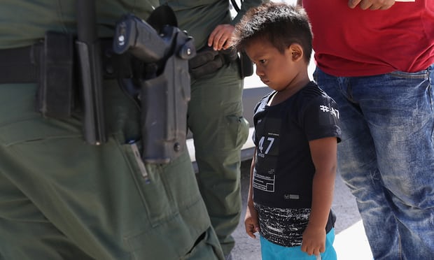 A boy and father from Honduras are taken into custody by US Border Patrol agents near Mission, Texas. Photograph: John Moore/Getty Images