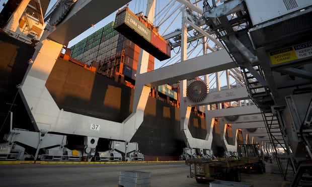 A crane loads shipping containers on to a vessel at the Port of Savannah in Georgia. Photograph: Stephen B. Morton/AP