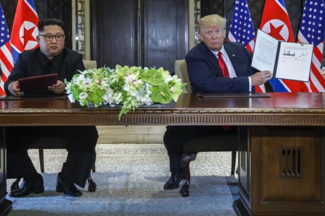 President Trump holds up the document that he and North Korea leader Kim Jong Un just signed in Singapore on Tuesday. (Photo: Evan Vucci/AP)