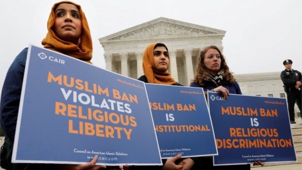 REUTERS / Protesters against the travel ban held signs outside the Supreme Court