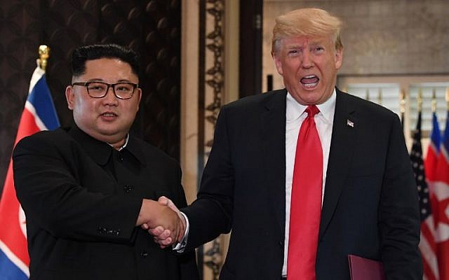 US President Donald Trump (R) and North Korea’s leader Kim Jong Un shake hands following a signing ceremony during their historic US-North Korea summit, at the Capella Hotel on Sentosa island in Singapore on June 12, 2018. (AFP PHOTO / 