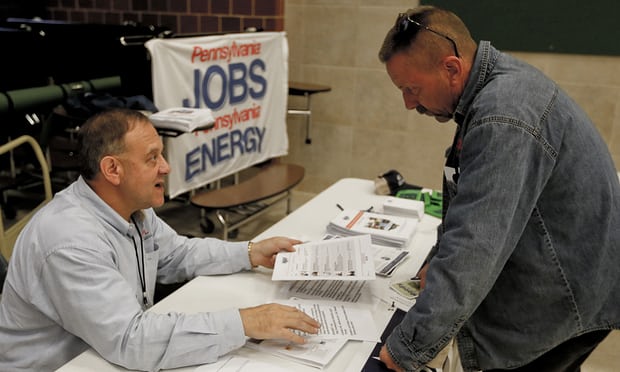 A recruiter in the shale gas industry, left, speaks with an attendee of a job fair in Cheswick, Pennsylvania. The US economy has now added jobs for 93 months in a row. Photograph: Keith Srakocic/AP