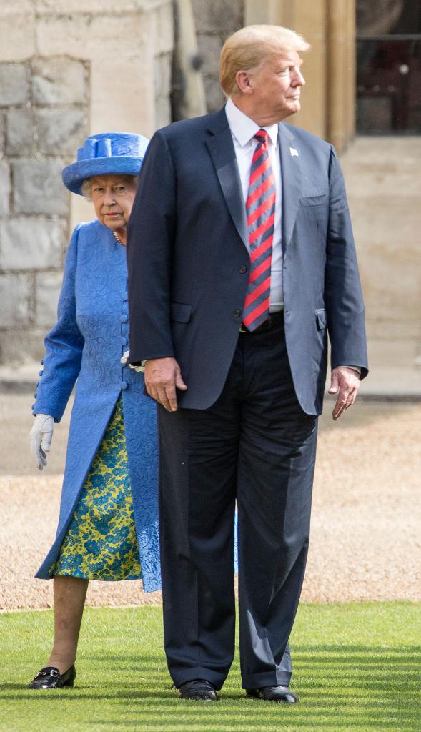 Queen Elizabeth walks with President Trump. (Photo: Getty Images)