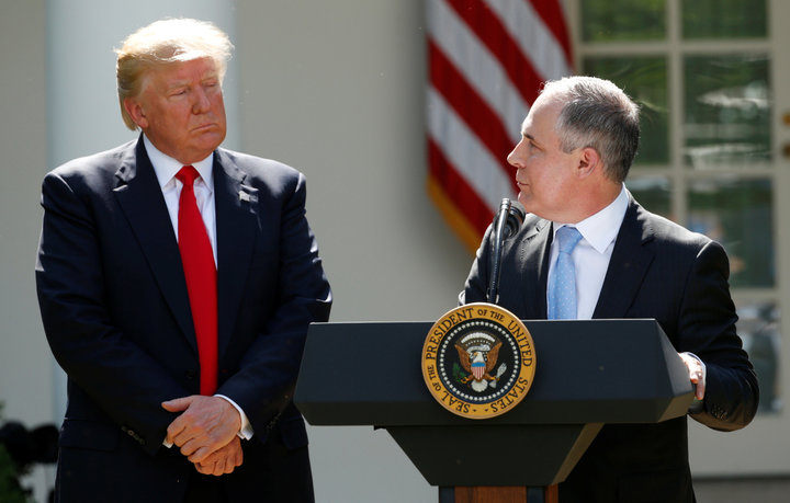 KEVIN LAMARQUE/REUTERS President Donald Trump listens to Scott Pruitt in the White House Rose Garden after announcing his decision to leave the Paris agreement in June 2017.