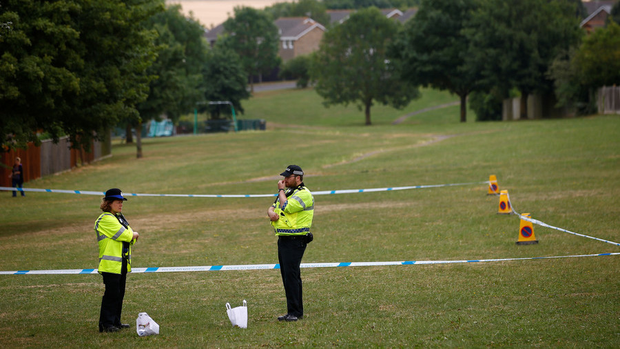 Police officers stand next to a section of a cordoned off playing field near Amesbury Baptist Church. © Henry Nicholls / Reuters