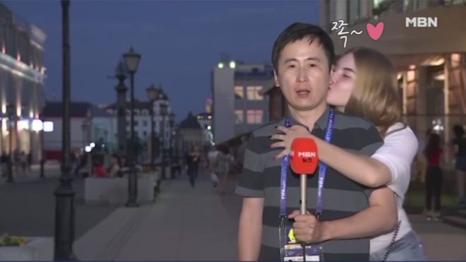 Jeon Gwang-ryeol being kissed by a jubilant Russian fan during live TV broadcast