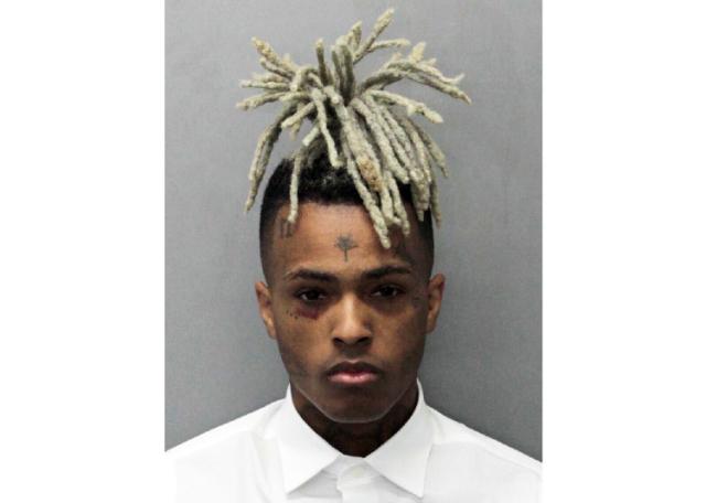 FILE - This undated photo released by the Miami-Dade Corrections & Rehabilitation Department shows rapper XXXTentacion. A Florida grand jury has indicted four men on first-degree murder and armed robbery charges in the shooting death of XXXTentacion. 