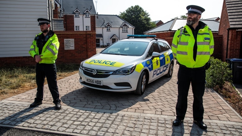 Police stand guard Thursday along Muggleton Road, where a man and woman were exposed to the Novichok nerve agent, in the English city of Amesbury. (Jack Taylor/Getty Images)