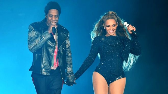 GETTY / caption Beyonce and Jay-Z's new album was illegally downloaded by many fans after being released exclusively on Tidal