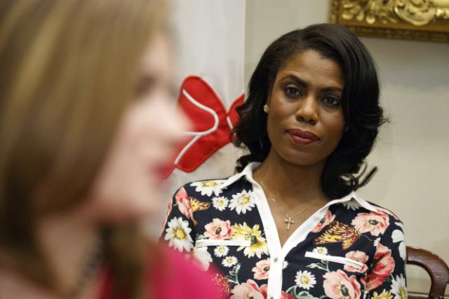 FILE - In this Feb. 14, 2017, file photo, Omarosa Manigault-Newman, then an aide to President Donald Trump, watches during a meeting with parents and teachers in the Roosevelt Room of the White House in Washington. The White House is slamming a new book b