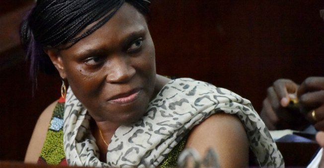 © Sia Kambou / AFP | Former Ivorian first lady Simone Gbagbo looks on at Abidjan's courthouse before the re-opening of her war crimes trial on October 10, 2016.