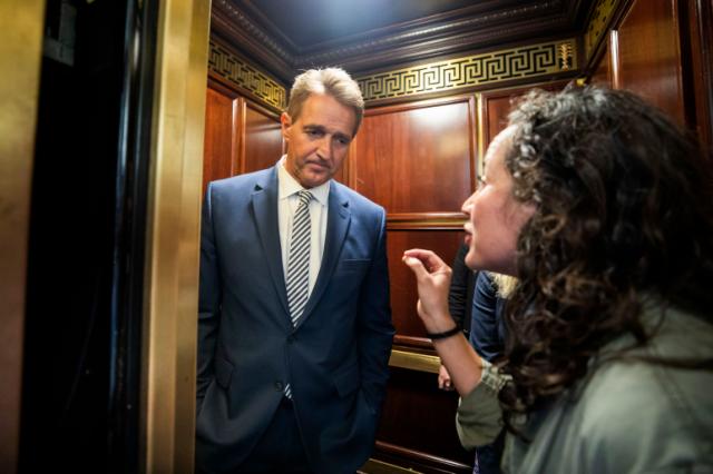 A woman who said she is a survivor of a sexual assault confronts Sen. Jeff Flake, R-Ariz., in an elevator in the Russell Senate Office Building in Washington, D.C,, on Friday. (Photo by Jim Lo Scalzo/EPA-EFE/REX/Shutterstock)