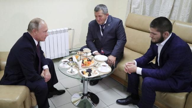Russian President Vladimir Putin, left, meets with Khabib Nurmagomedov, right, who has won the UFC lightweight title, in Ulyanovsk on the Volga River, Russia, Wednesday, Oct. 10, 2018. Putin defended the fighter's actions in the brawl that followed h