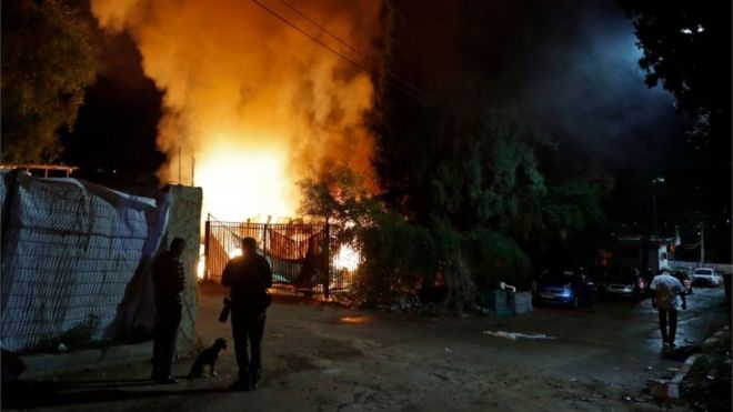 AFP / An empty bus in a kibbutz was set ablaze after being hit and an Israeli seriously wounded