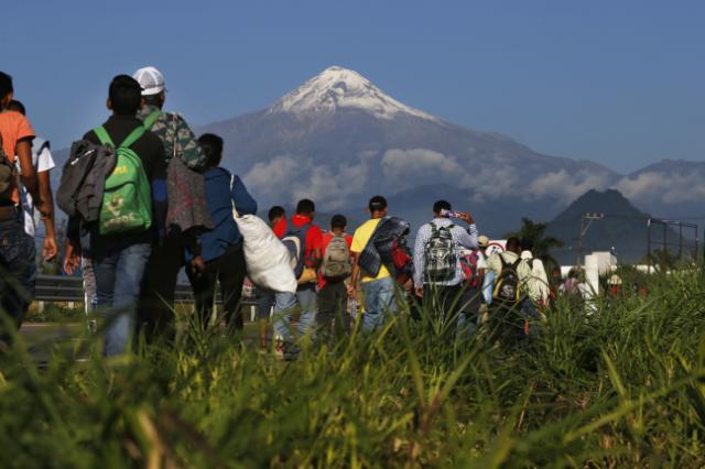 Caravan migrants arrive in Mexico City, bed down in stadium