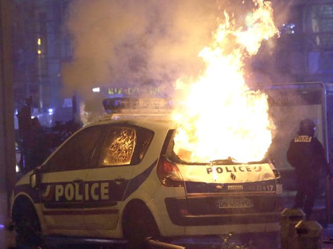 A police car burns after clashes between police and protesters, in Marseille, southern France. Picture: APSource:AP