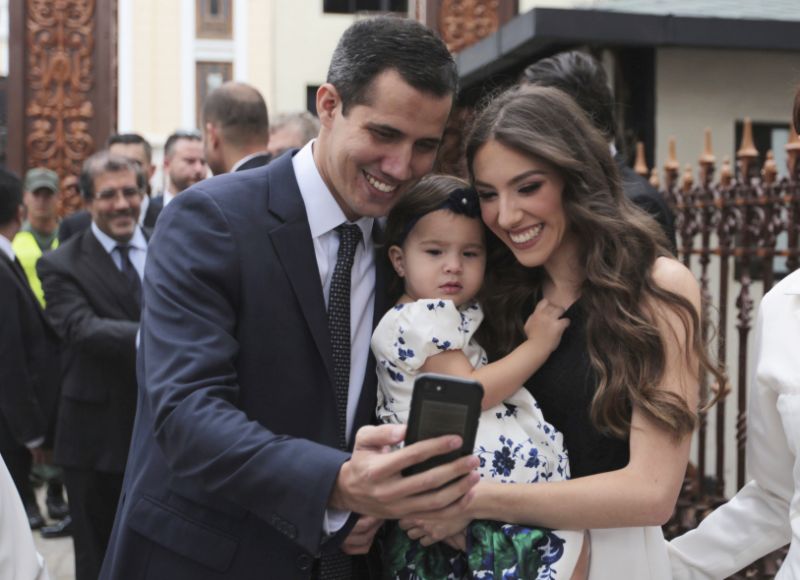 Incoming parliamentary president Juan Guaido, left, takes a selfie photo with his wife Fabiana Rosales and his daughter Miranda Guaido upon his arrival to swears in the new board of the National Assembly in Caracas, Venezuela, Saturday, Jan. 5, 2019. Vene
