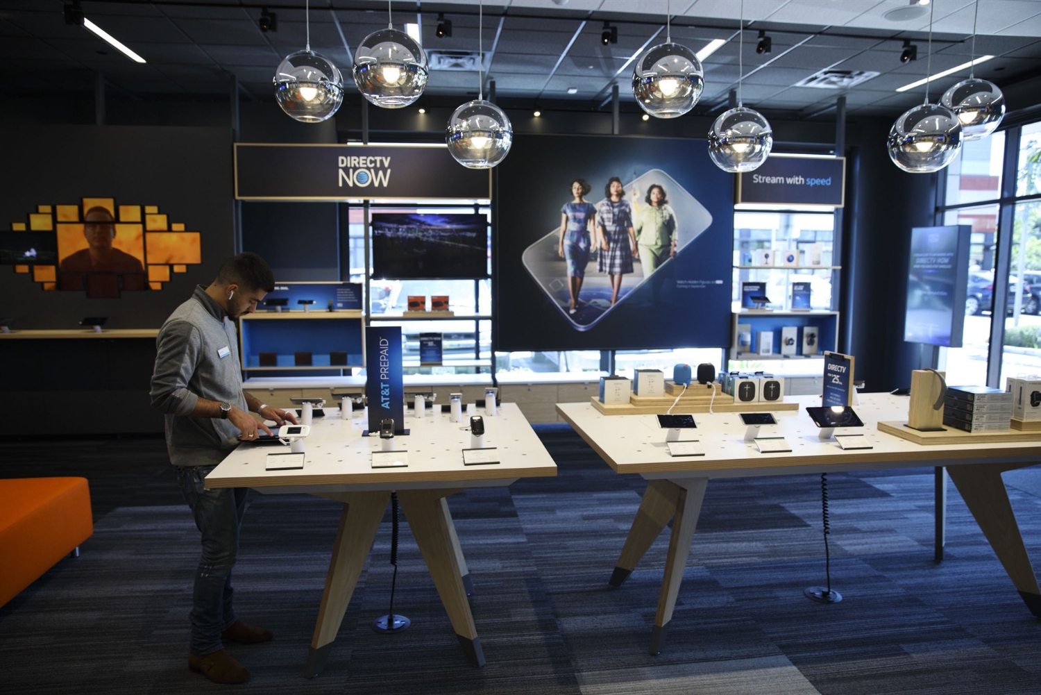 An employee uses a tablet computer at an AT&T store in Newport Beach, California, on Aug. 10, 2017.Patrick T. Fallon / Bloomberg via Getty Images