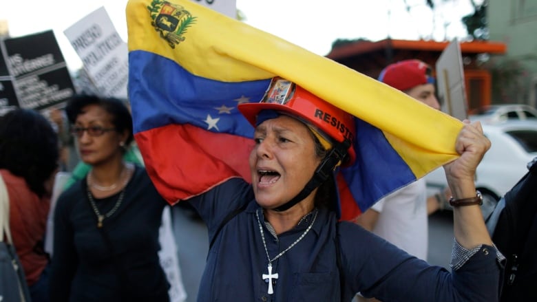 A woman holds a Venezuelan flag during a march in honour of protesters killed during months of deadly protests against Venezuelan President Nicolas Maduro in Caracas, Venezuela, on Aug. 30, 2017. Opposition activists have planned fresh protests on Wednesd