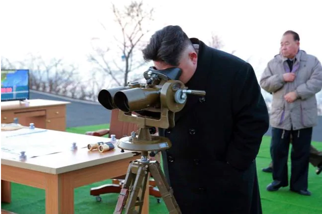 In this March 6, 2017, photo distributed by the North Korean government, leader Kim Jong Un looks through a scope at an observation point to watch the launching of Scud missiles in Tongchang-ri in North Pyongan Province, North Korea. Picture: APSourc