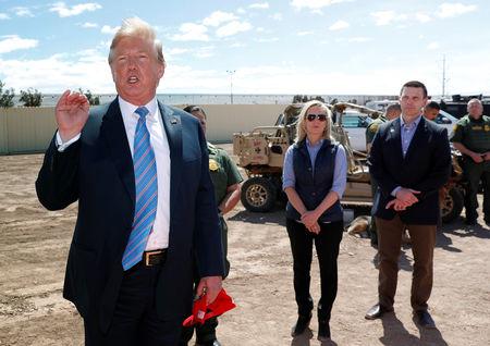 FILE PHOTO: Homeland Security Secretary Kirstjen Nielsen and commissioner for Customs and Border Patrol Kevin McAleenan listen to U.S. President Donald Trump speak during a visit to a section of border wall in Calexico California, U.S., April 5, 2019