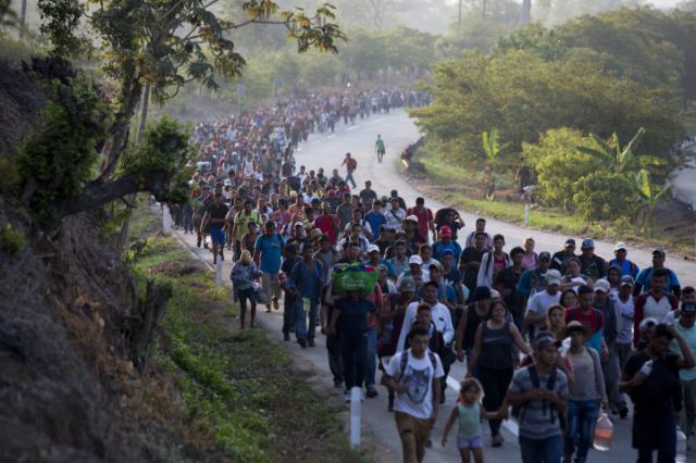 Central American migrants, part of a caravan hoping to reach the U.S. border, move on the road in Escuintla, Chiapas State, Mexico, Saturday, April 20, 2019. Thousands of migrants in several different caravans have been gathering in Chiapas in recent days