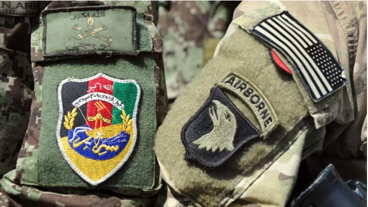 Badges on the arms of a U.S. and an Afghan soldier are seen during a training session at the U.S. Shinwar Forward Base in the province of Nangarhar, Afghanistan, in April 2013. Judges at the International Criminal Court have rejected a request by the ICC