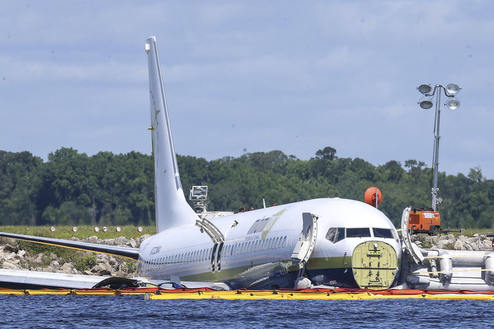 SSOCIATED PRESS / The charter plane sitting in the river on Saturday.