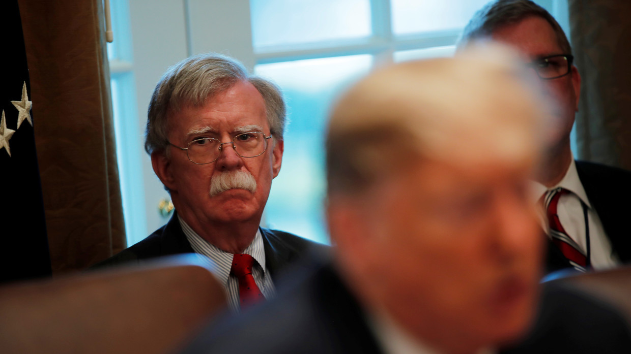 John Bolton sits behind Donald Trump during a White House event earlier this year. ©  REUTERS/CARLOS BARRIA