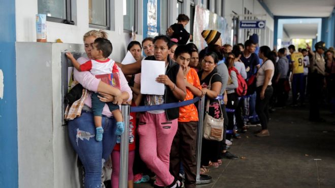 REUTERS / Venezuelans queue at an immigration office in the border town of Tumbes