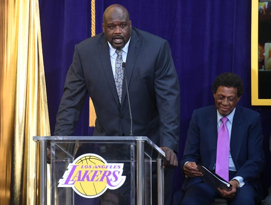 Former Los Angeles Lakers player Shaquille O'Neal (L) speaks during a statue unveiling for former player Elgin Baylor (R) prior to the game between the Los Angeles Lakers and the Minnesota Timberwolves at Staples Center. (Photo&#x