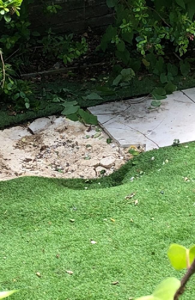 The impact zone where the frozen body landed just one metre from a man sunbaking in his garden.Source:The Sun