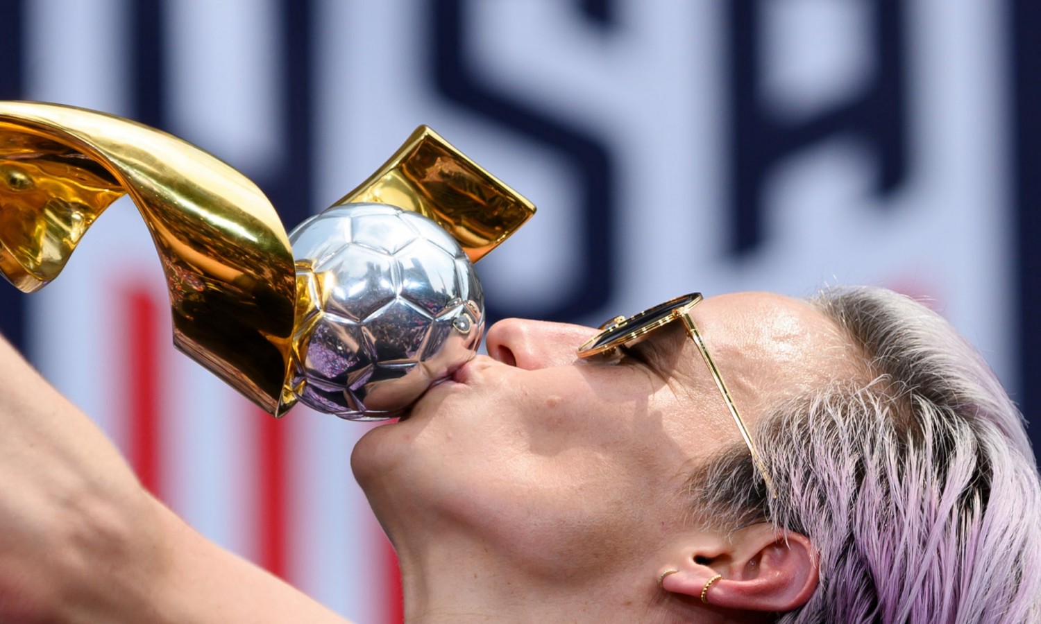 US women’s soccer co-captain Megan Rapinoe kisses the trophy in front of New York’s City Hall after the ticker-tape parade for the world champions. Photograph: Johannes Eisele/AFP/Getty Images