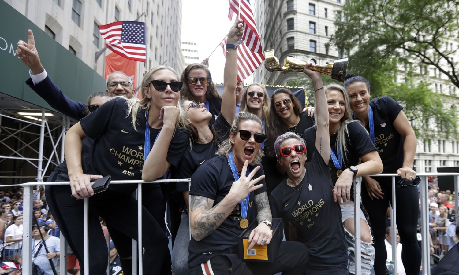 Megan Rapinoe holds the Women’s World Cup trophy on the parade float. Photograph: Richard Drew/AP