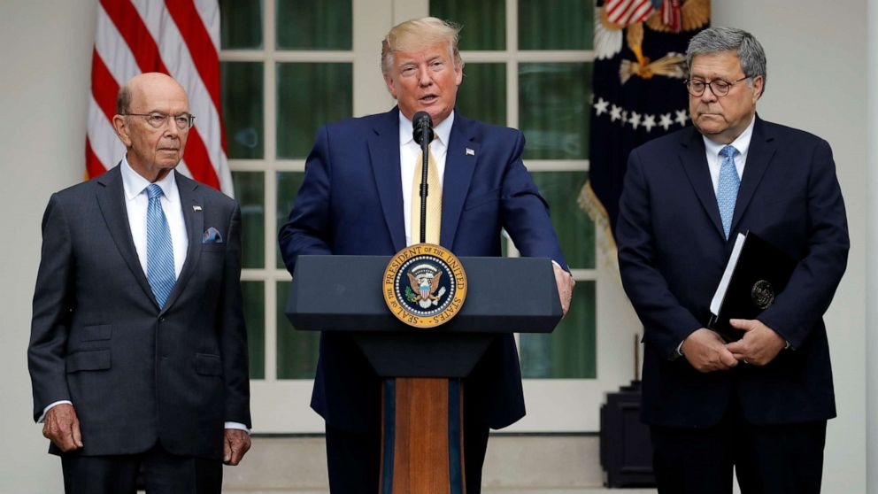 U.S. President Donald Trump stands between Commerce Secretary Wilbur Ross, left, and Attorney General Bill Barr, right, to announce his administration's effort to gain citizenship data during an event at the White House Rose Garden in Washington on T