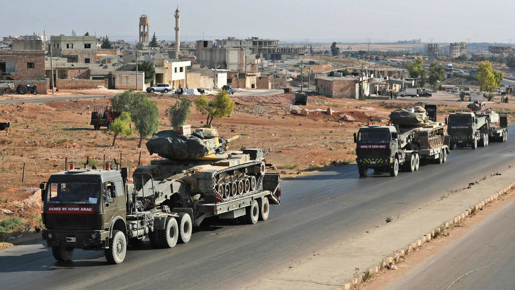 Omar Haj Kadour, AFP | A convoy of Turkish military vehicles passes through the town of Saraqeb in the northwestern province of Idlib reportedly heading toward the town of Khan Sheikhun in the southern countryside of the province on August 19, 2019.