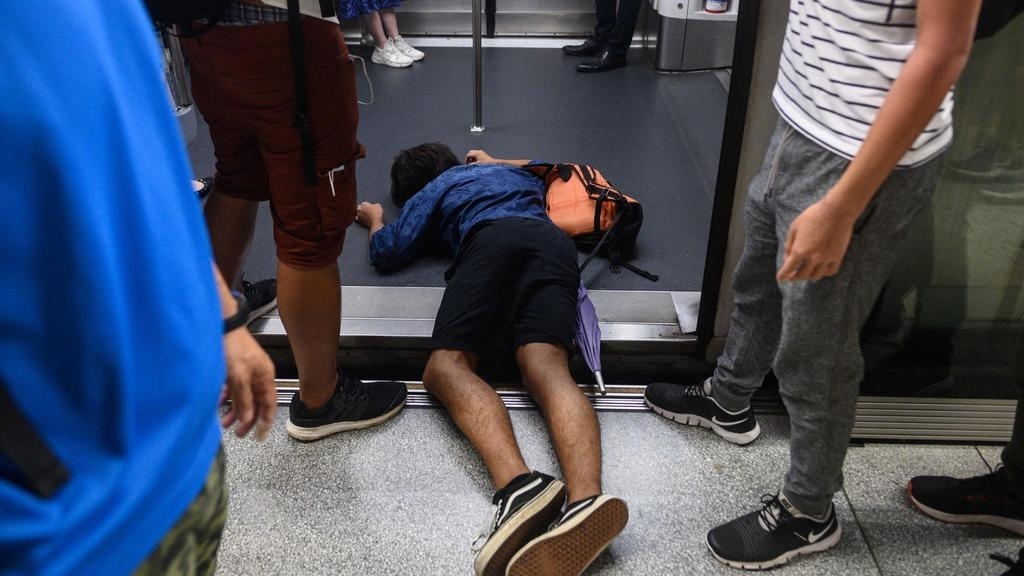 Hong Kong protesters disrupt trains, flights as part of territory-wide strike