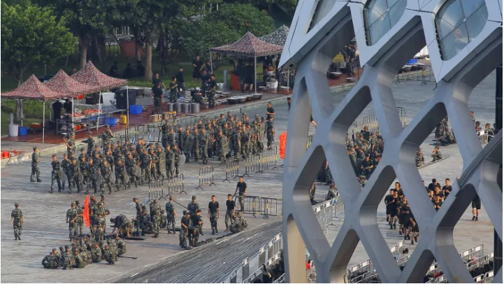 Chinese soldiers walk in formation on the grounds of the Shenzhen Bay Sports Center on Thursday in the city of Shenzhen, across the bay from Hong Kong. (Thomas Peter/Reuters)