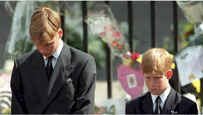 Prince William and Prince Harry bow their heads as their mother's coffin is taken out of Westminster Abbey. Picture: AFP PHOTO / POOL / ADAM BUTLERSource:AFP
