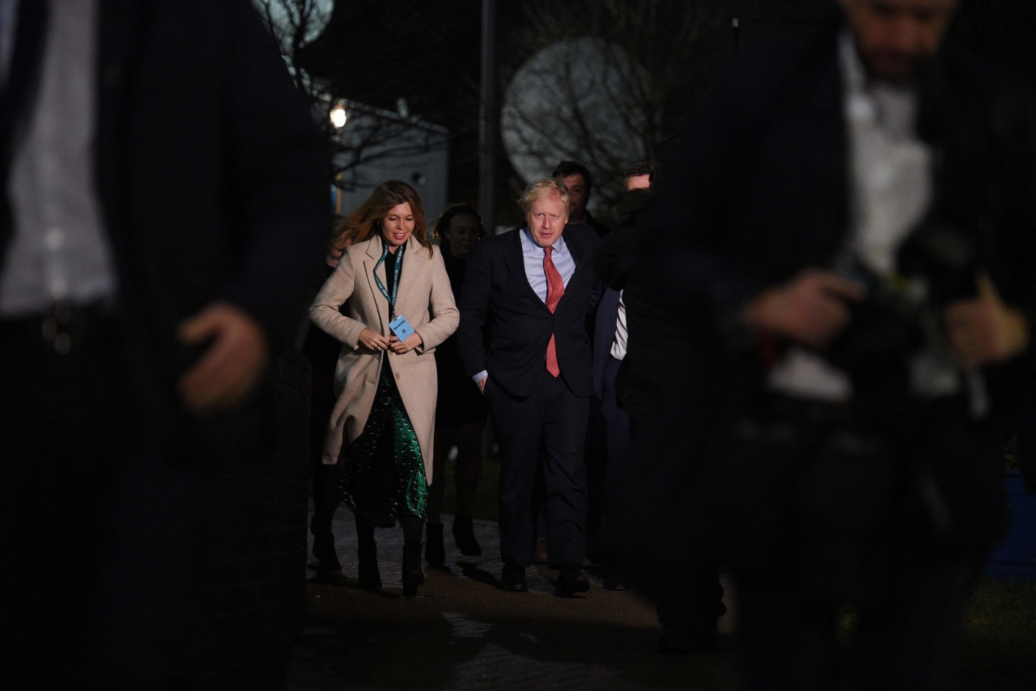 Prime Minister Boris Johnson, center right, and his partner, Carrie Symonds, arriving at the vote counting center in Uxbridge in west London early Friday.Credit...Oli Scarff/Agence France-Presse — Getty Images