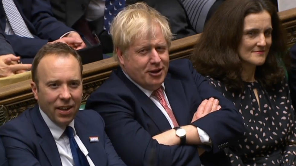 A video grab from footage broadcast by the UK Parliament's Parliamentary Recording Unit shows Britain's Prime Minister Boris Johnson (C) reacting after his Government won the vote on the third reading of the EU (Withdrawal Agreement&