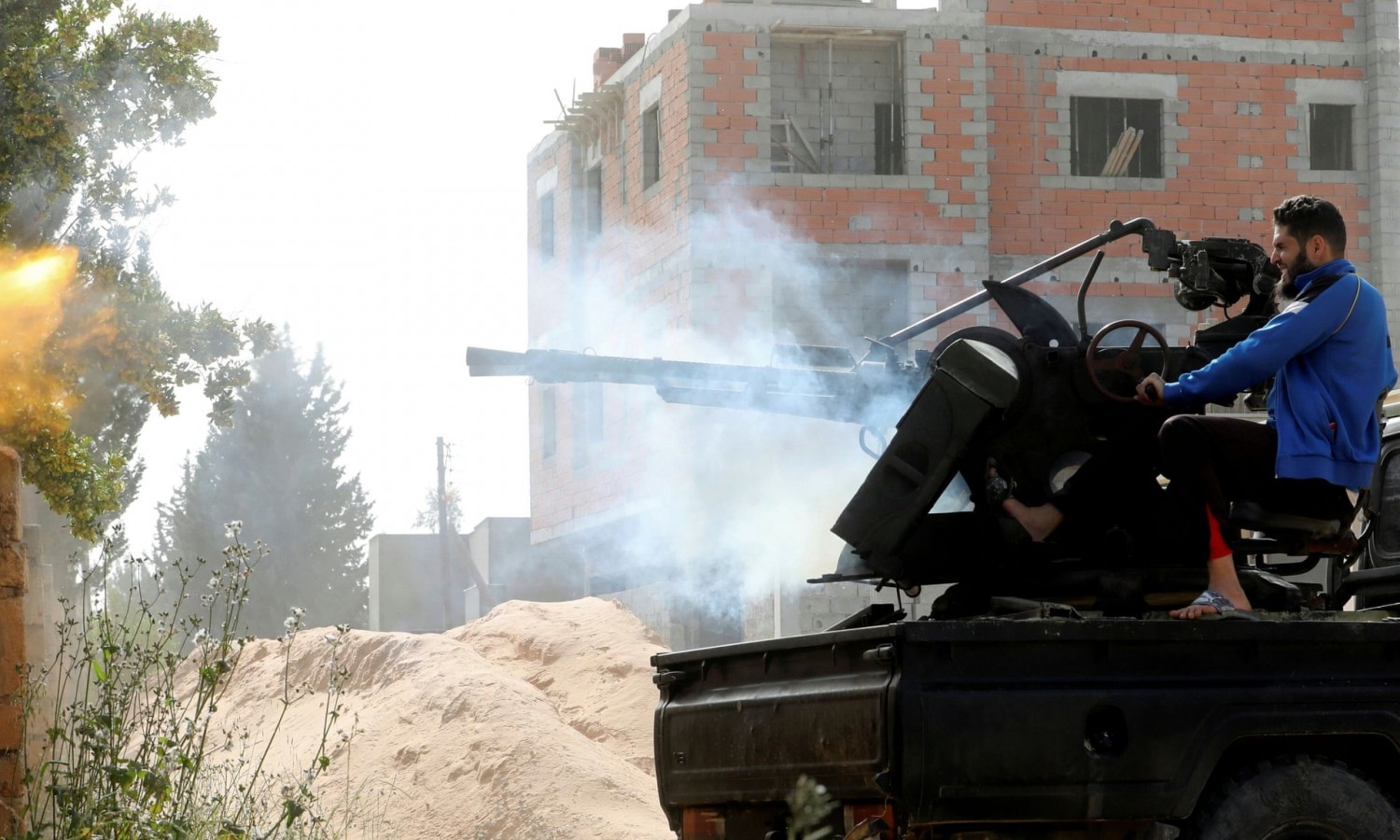 A member of the Tripoli government forces fires during a fight with eastern troops. Photograph: Hani Amara/Reuters