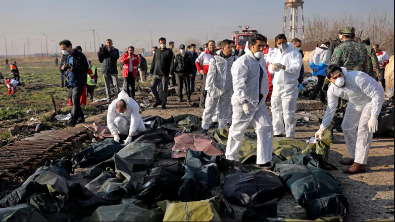 Forensic investigators work at the scene of a Ukrainian plane crash as bodies of victims are collected, in Shahedshahr, southwest of the capital Tehran, on Wednesday. (Ebrahim Noroozi/Associated Press)