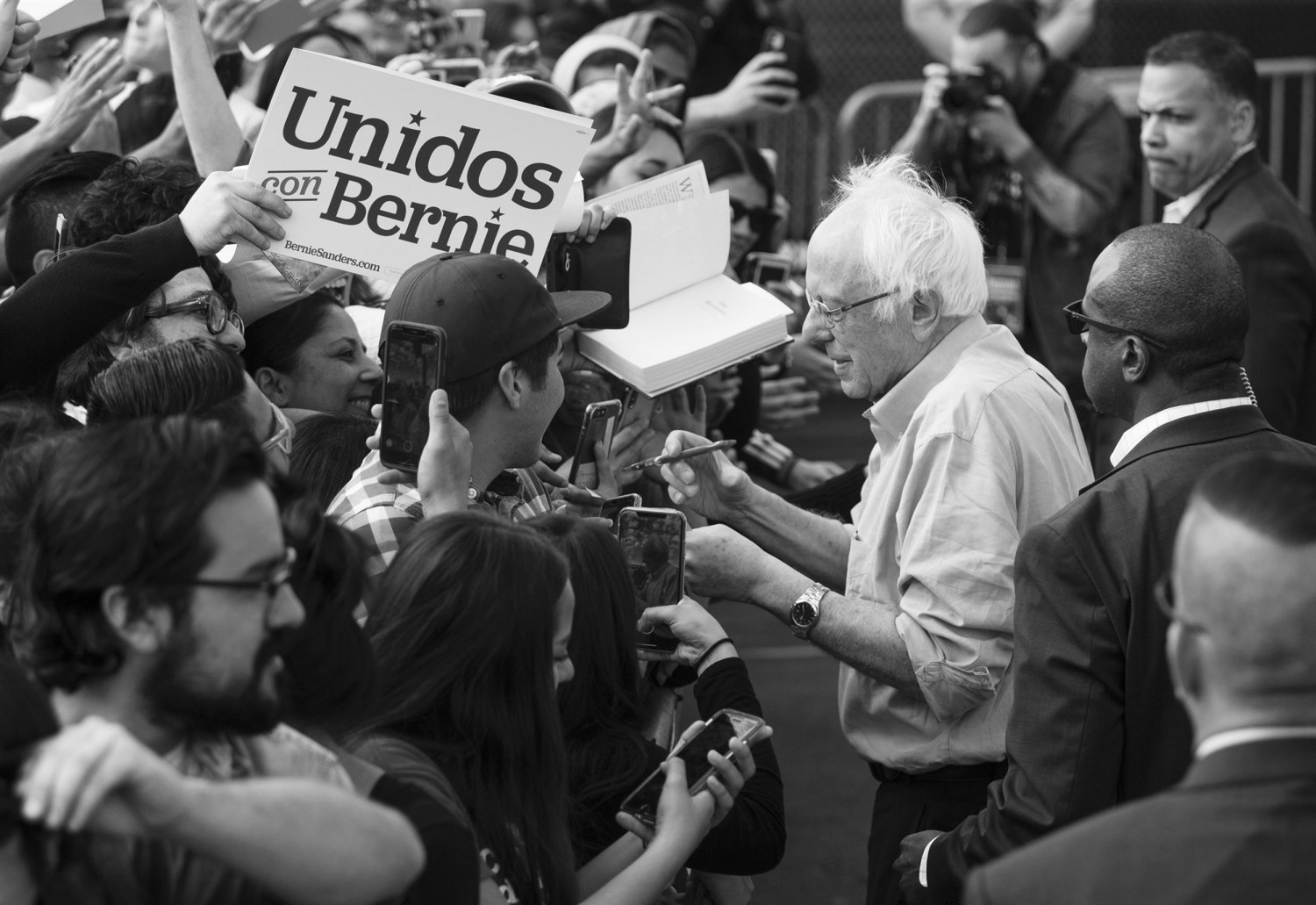 Sen. Bernie Sanders, I-Vt., signs autographs for Latino supporters at a campaign event at Valley High School in Santa Ana, Calif., on Feb. 21, 2020.Damian Dovarganes / AP