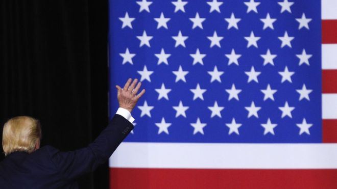 GETTY IMAGES // Donald Trump waves goodbye to a crowd in Iowa, as well as to his impeachment trial