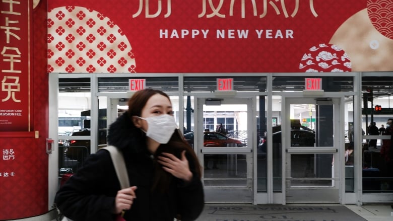 People wear masks out of concern over the coronavirus at the terminal that serves planes bound for China, at John F. Kennedy Airport in New York City on Friday. (Spencer Platt/Getty)