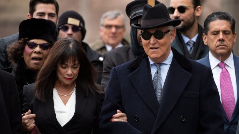 Roger Stone accompanied by his wife Nydia Stone, left, arrives for his sentencing at federal court in Washington on Thursday. The staunch ally of U.S. President Donald Trump had earlier filed a motion pressing for a new trial. (Manuel Balce Ceneta�