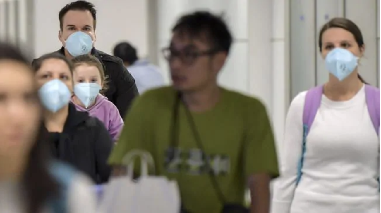 Passengers, wearing masks as a precautionary measure to avoid contracting the Covid-19 virus, travel through Guarulhos International Airport, in Sao Paulo, Brazil. Picture: Nelson Almeida/AFPSource:AFP