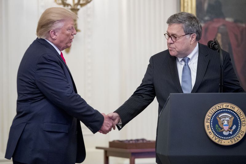 President Trump shakes hands with Attorney General William Barr during an event at the White House last year. (Andrew Harnik/AP)